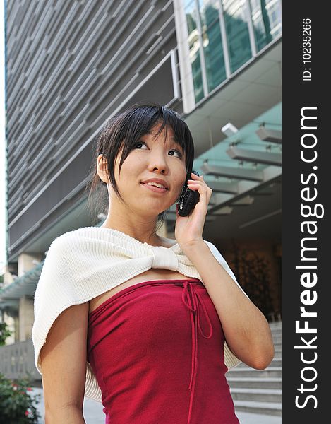 Asian Chinese Woman answering her mobile phone