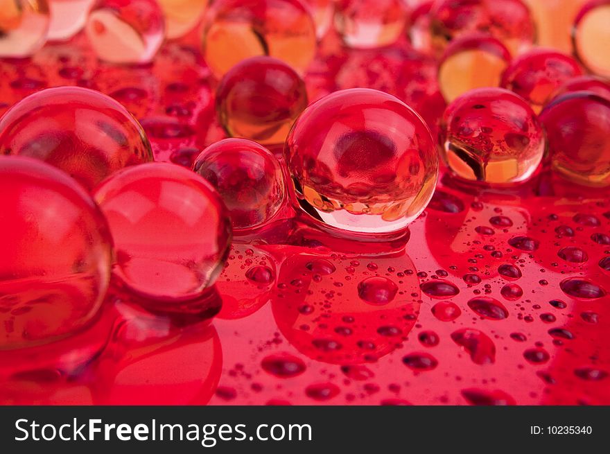 Balls and drops water on red surface. Balls and drops water on red surface