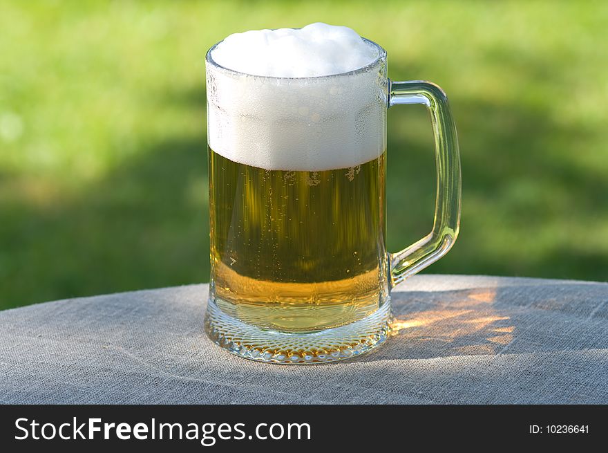 Beer mug on a table of outdoor. Beer mug on a table of outdoor