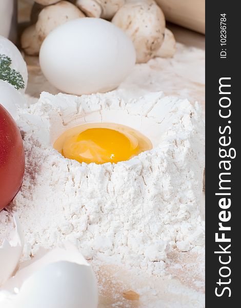 Close up shot of egg on heap of flour