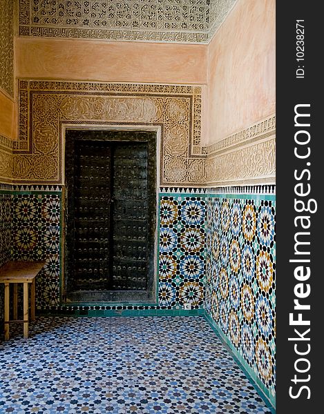 An ornate door surround by designed Moroccan tile on the walls. An ornate door surround by designed Moroccan tile on the walls.