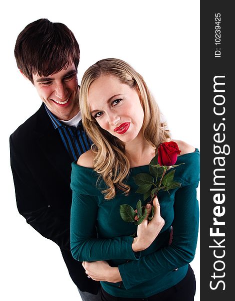 A happy couple poses with a girl holding a rose. A happy couple poses with a girl holding a rose