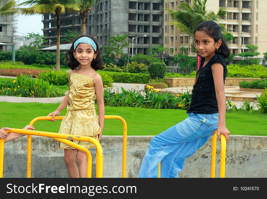 Two girls happily playing in their society park. Two girls happily playing in their society park.