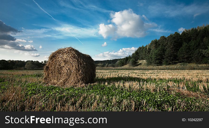 Haystack, foeld, clouds, blue sky on autumn day. Haystack, foeld, clouds, blue sky on autumn day.