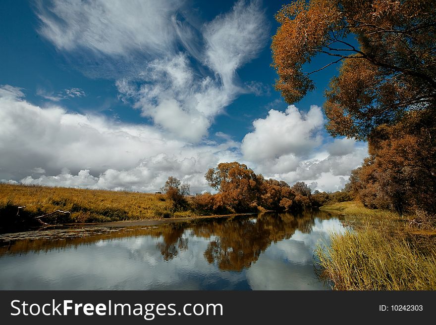 River,trees and blue sky with clouds. River,trees and blue sky with clouds.
