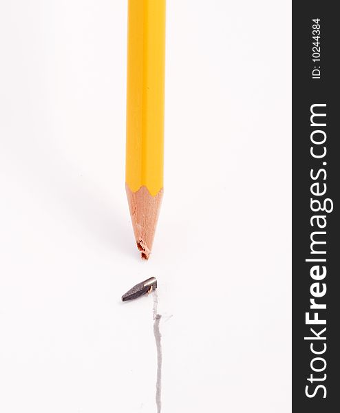 Yellow pencil with broken tip after drawing a straight line on a white background. Yellow pencil with broken tip after drawing a straight line on a white background.