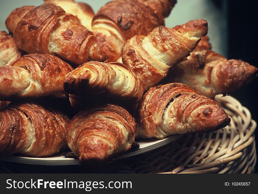 Wooden plate with fresh sweet croissants