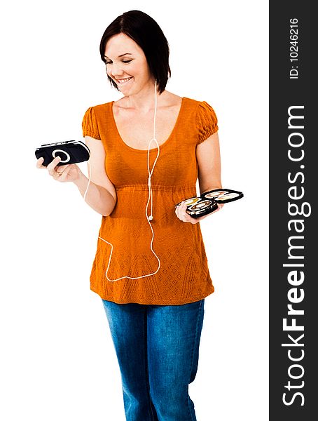 Young woman listening to music on an media player isolated over white. Young woman listening to music on an media player isolated over white