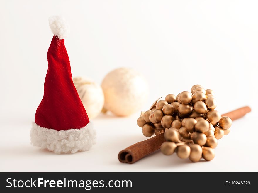 Christmas balls, Santa Claus hat  and a cinamon stick. Christmas balls, Santa Claus hat  and a cinamon stick