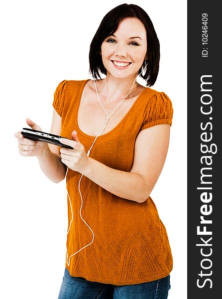 Beautiful woman listening to music on an media player isolated over white. Beautiful woman listening to music on an media player isolated over white