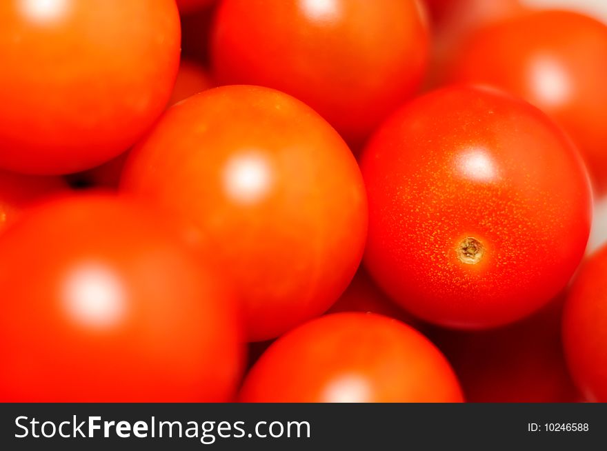 Closeup of small red cherry tomatoes group. Closeup of small red cherry tomatoes group