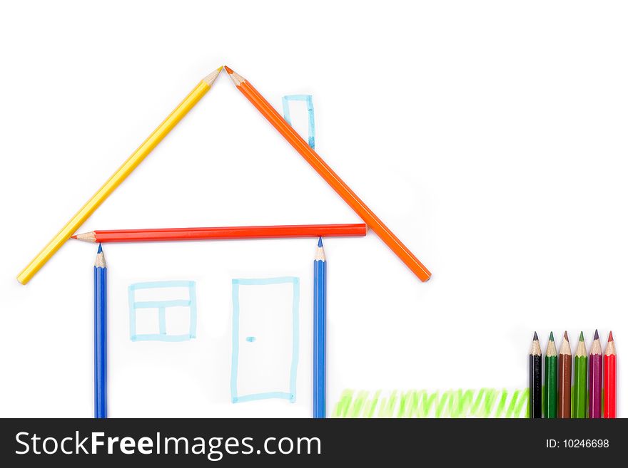 Color pencils formed in the shape of a house. Isolated on white background. Color pencils formed in the shape of a house. Isolated on white background.