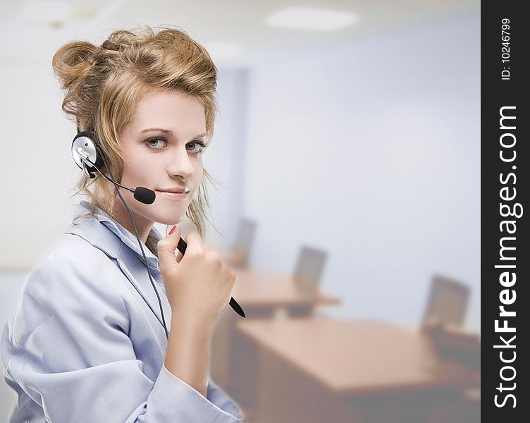 Woman wearing headset indoors in the office