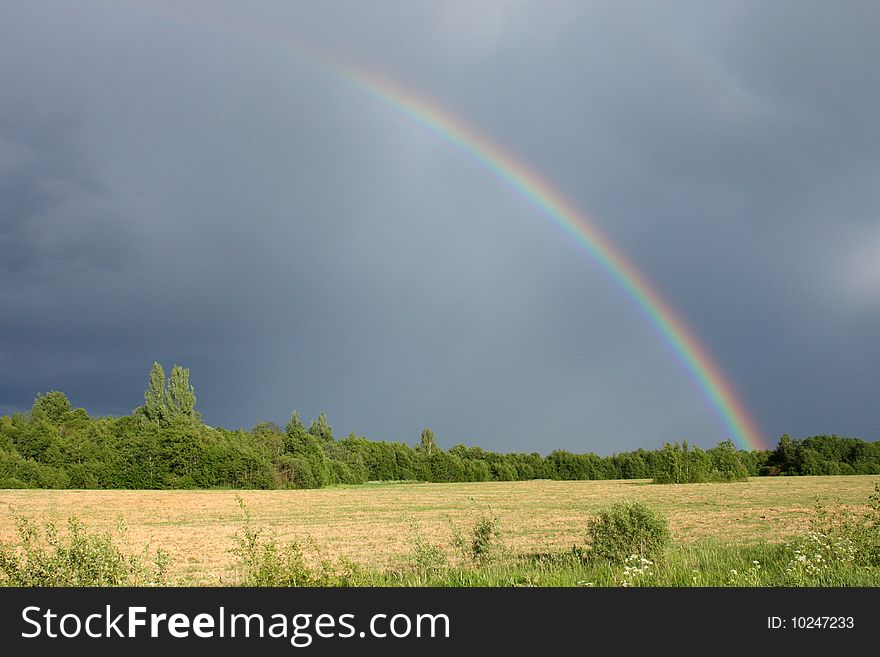 Rainbow between storm and sun