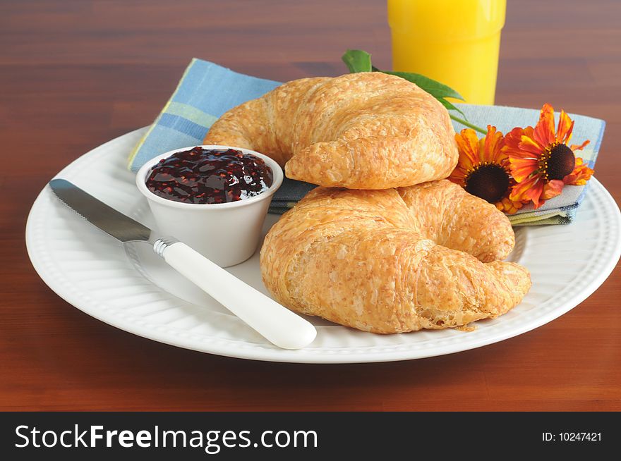 Fresh baked flaky croissants served with jam.