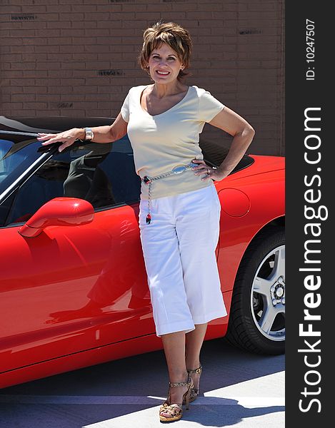 Attractive Woman with her Red Sports Car