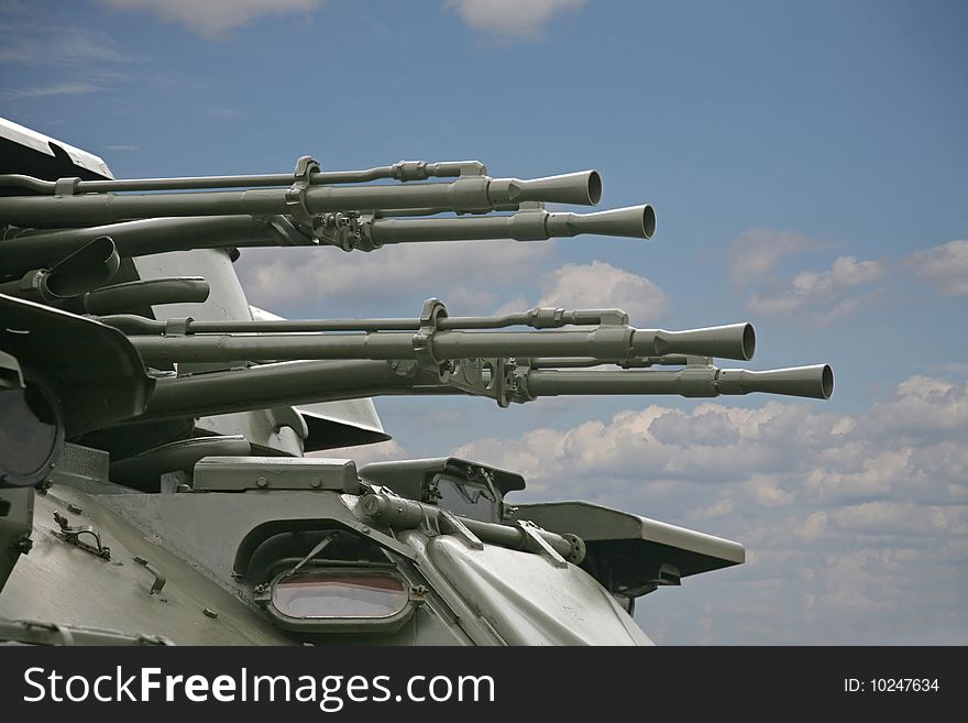 Trunks of an antiaircraft gun against the blue sky. Trunks of an antiaircraft gun against the blue sky