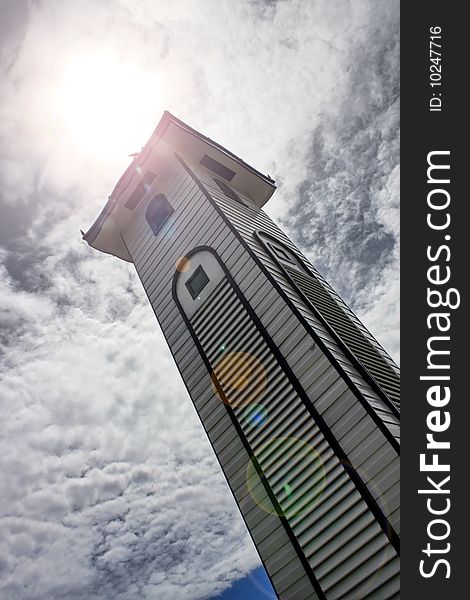 Atkinson Clock Tower over cloudy sky with sunlight at Kota Kinabalu city.