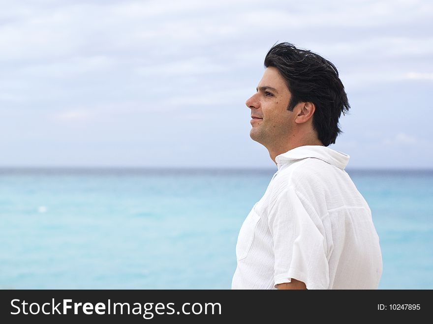 Man in a beach resort with blue caribbean sea. Man in a beach resort with blue caribbean sea