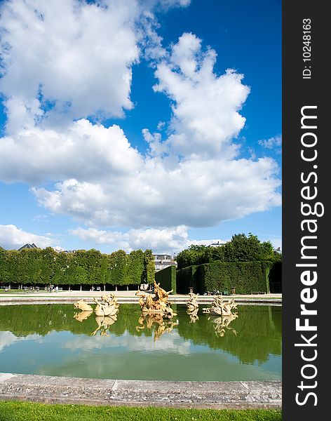 Classic fountain in paris royal park with water reflection