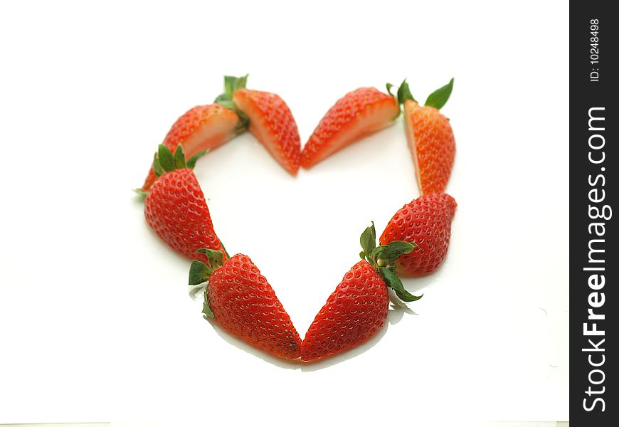 Strawberry slices that form a heart on a white bg. Strawberry slices that form a heart on a white bg.