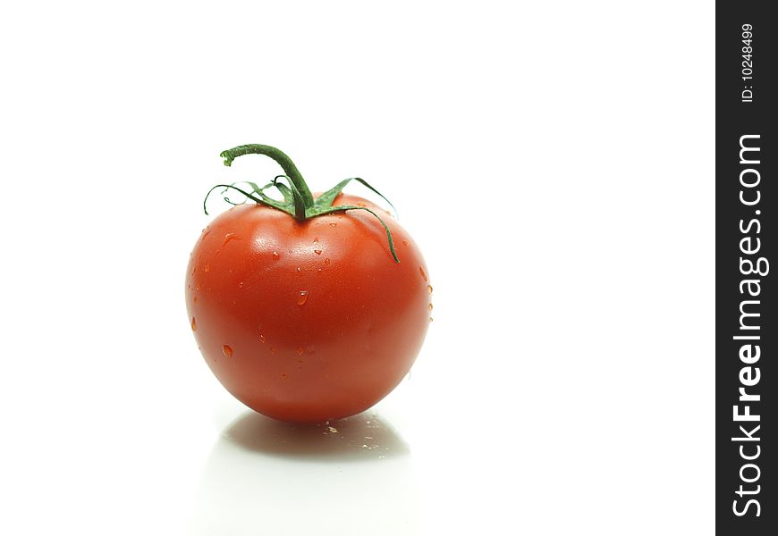 A juicy tomato fresh off the vine isolated on a white background.
