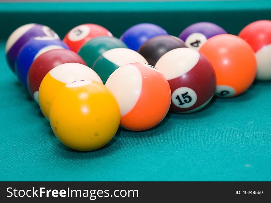 Pool billiard balls on a green table