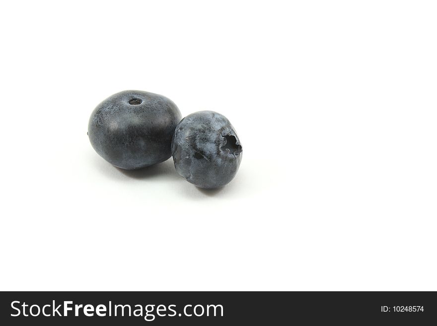 Two Blue berries on a white background. Two Blue berries on a white background.