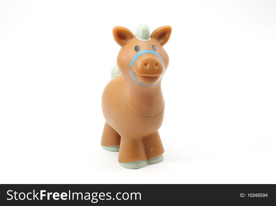 A toy brown horse looking at you on a white background. A toy brown horse looking at you on a white background.