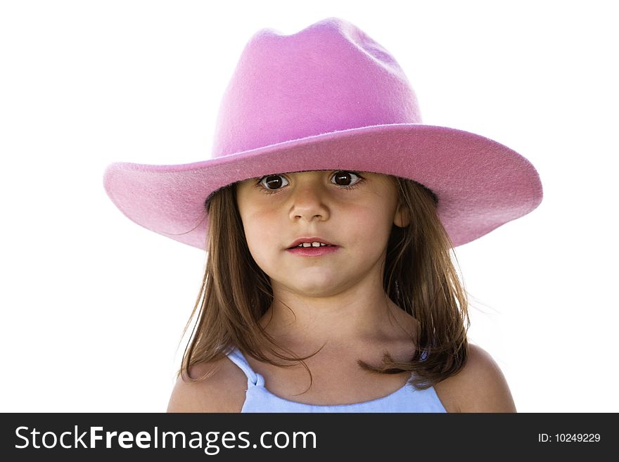 A cute little girl wears her cowboy hat low on her head acting silly. A cute little girl wears her cowboy hat low on her head acting silly