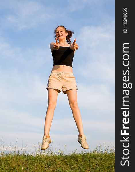 Woman jump in field under blue sky