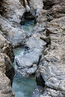Narrow Mountain Stream Flows Among Blue Striped R Royalty Free Stock Image Narrow Mountain Stream Flows Among Blue Striped R Royalty Free Stock Image