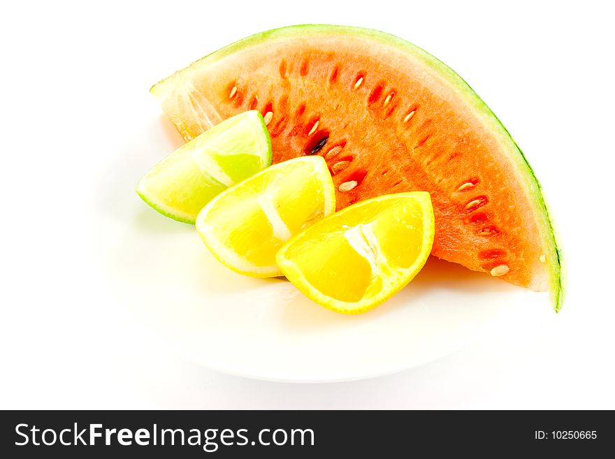 Lemon, lime and orange wedges with a slice of juciy watermelon on a white background. Lemon, lime and orange wedges with a slice of juciy watermelon on a white background