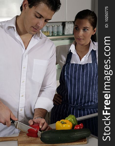 Young couple in kitchen cooking