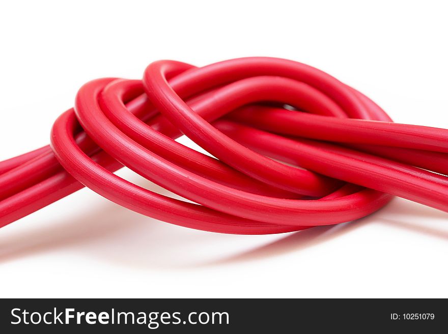 Tie of red plastic wires isolated over white background. Tie of red plastic wires isolated over white background