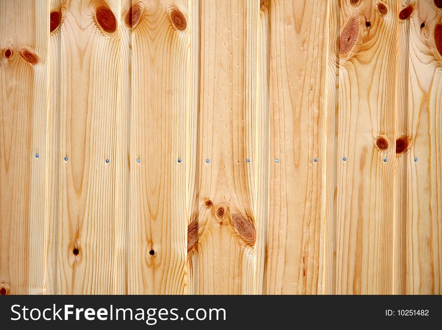 A wooden pine panel with nails. A wooden pine panel with nails.