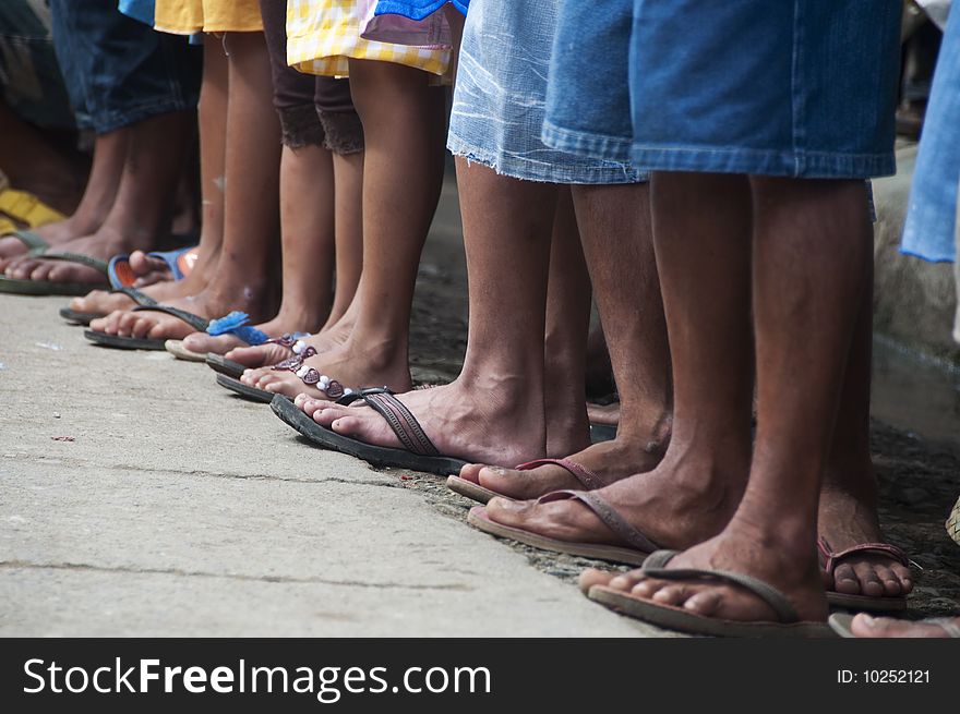 A line of feet of spectators in a rural area