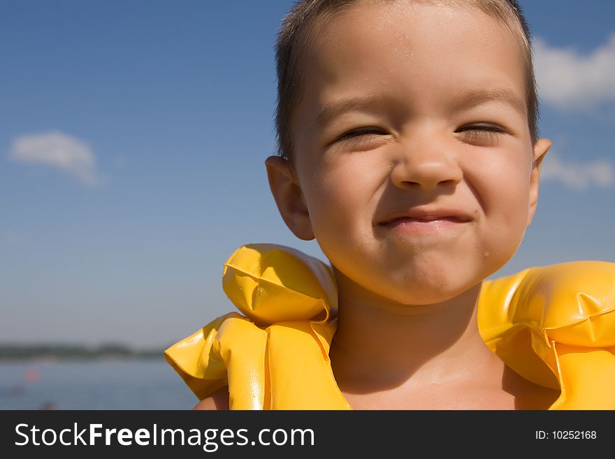 Kid with swiming vest weared in water