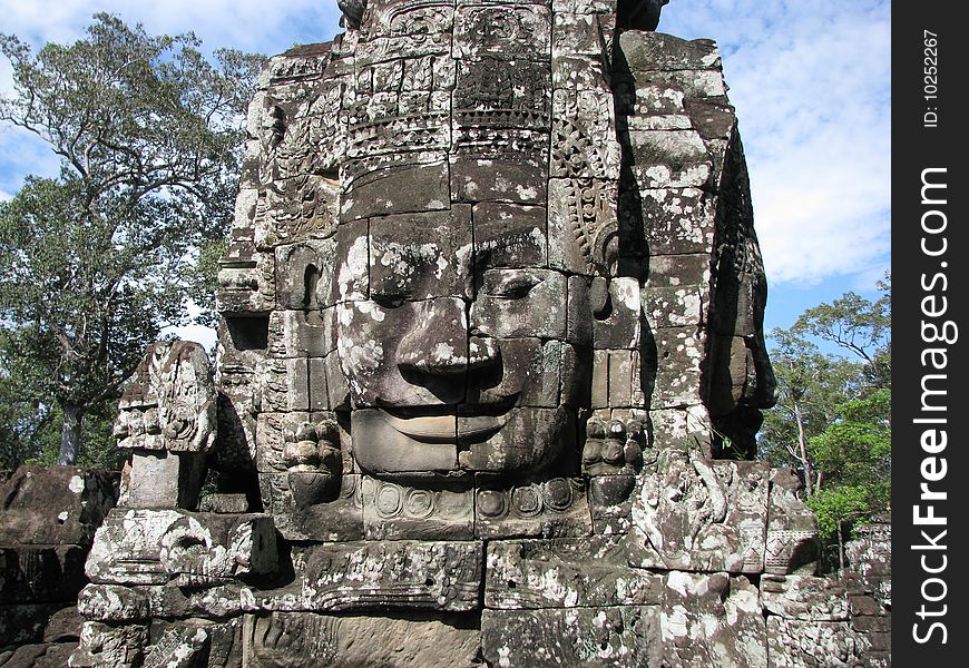 Photo of an iconic face on the bayon temple near siem reap, cambodia.