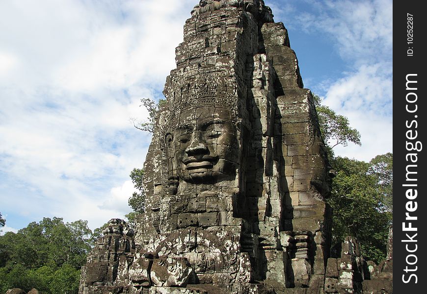 Photo of an iconic face on the bayon temple near siem reap, cambodia.