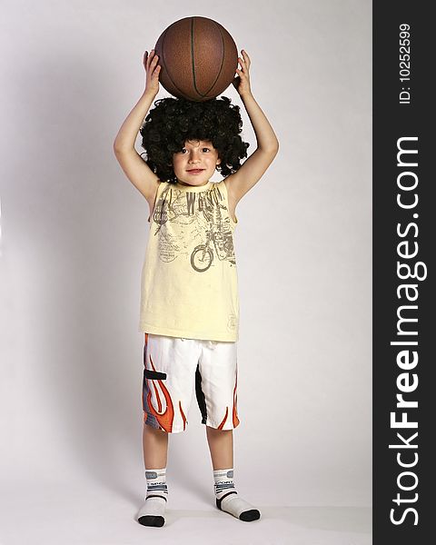 Boy in the wig put the ball on a head. Boy in the wig put the ball on a head