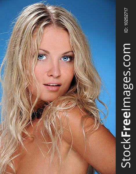 Attractive young blonde woman. portrait on blue. Attractive young blonde woman. portrait on blue.