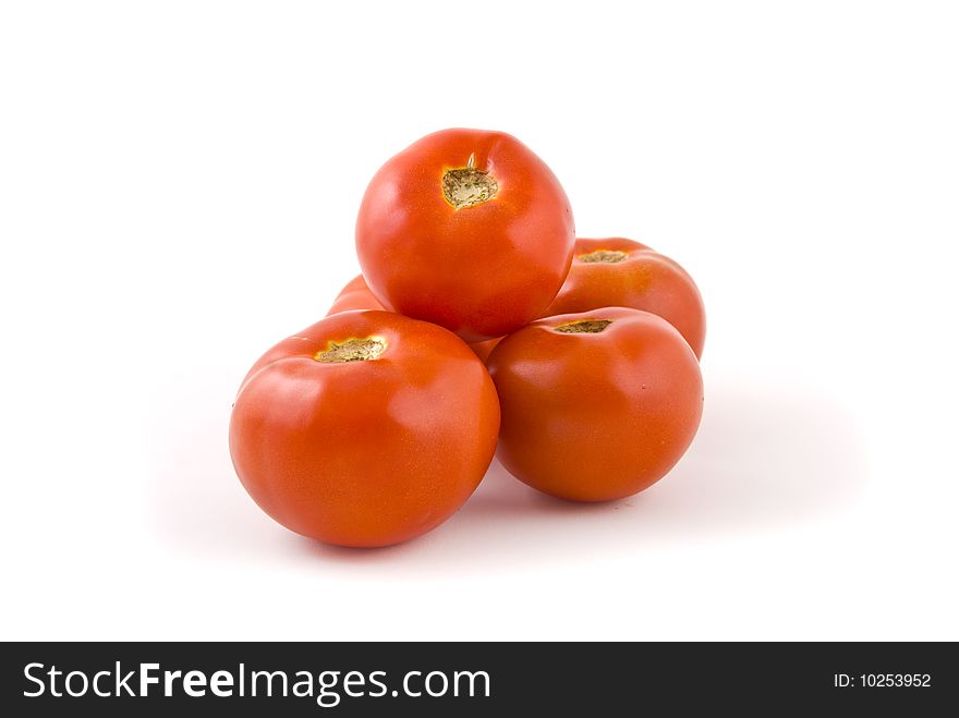 Heap of red tomatoes on white