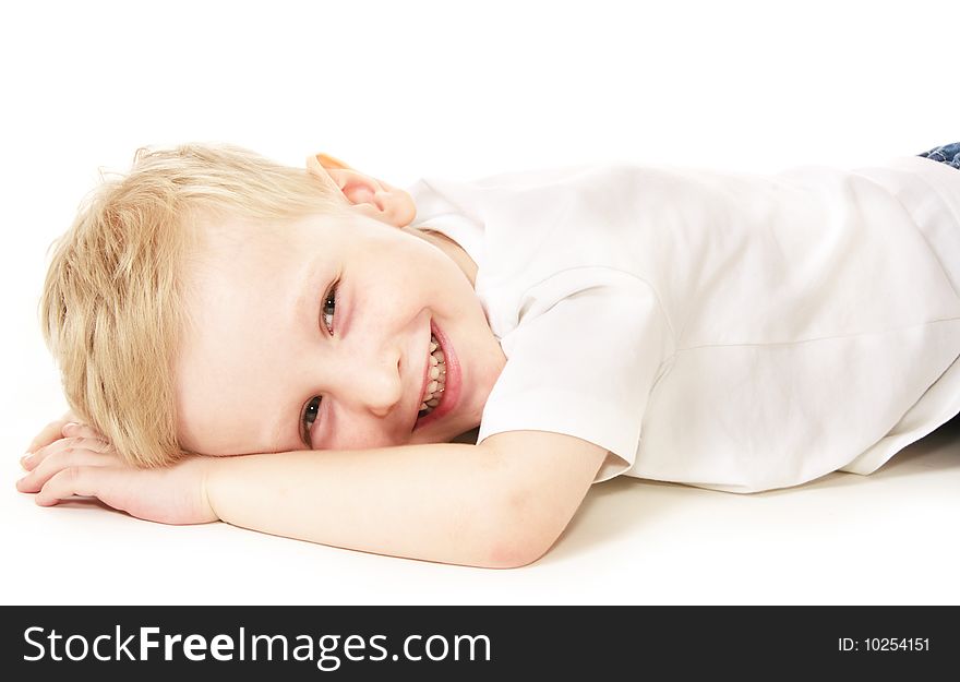 Laughing little boy laying on floor