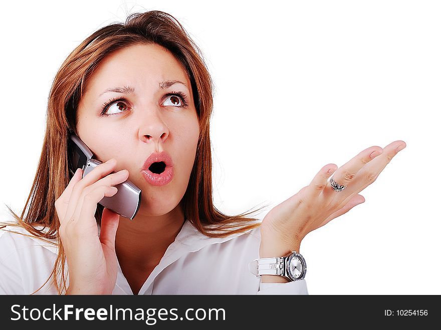 Young brunette with surprised expression on face speakin on cell phone