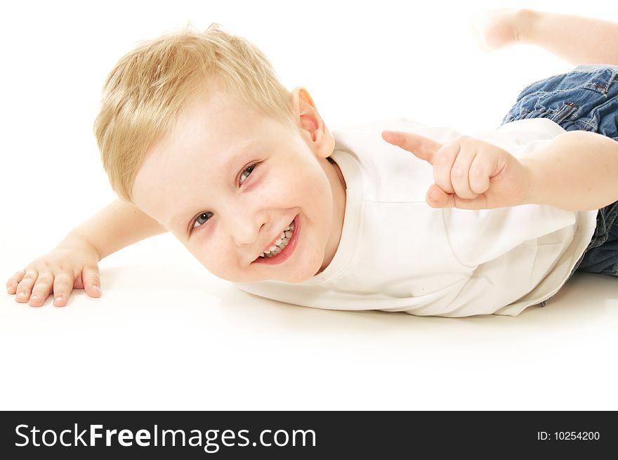 Laughing little boy laying on floor