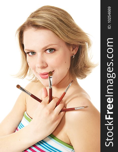 Blond woman holding four make-up brushs