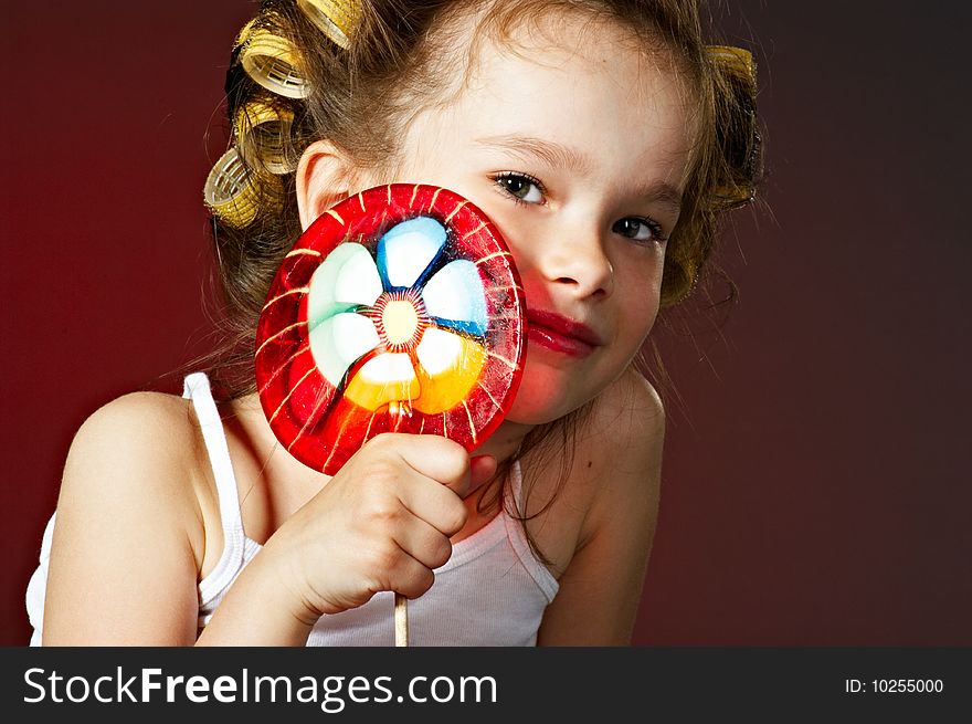 Closeup portrait of little girl with lollipop