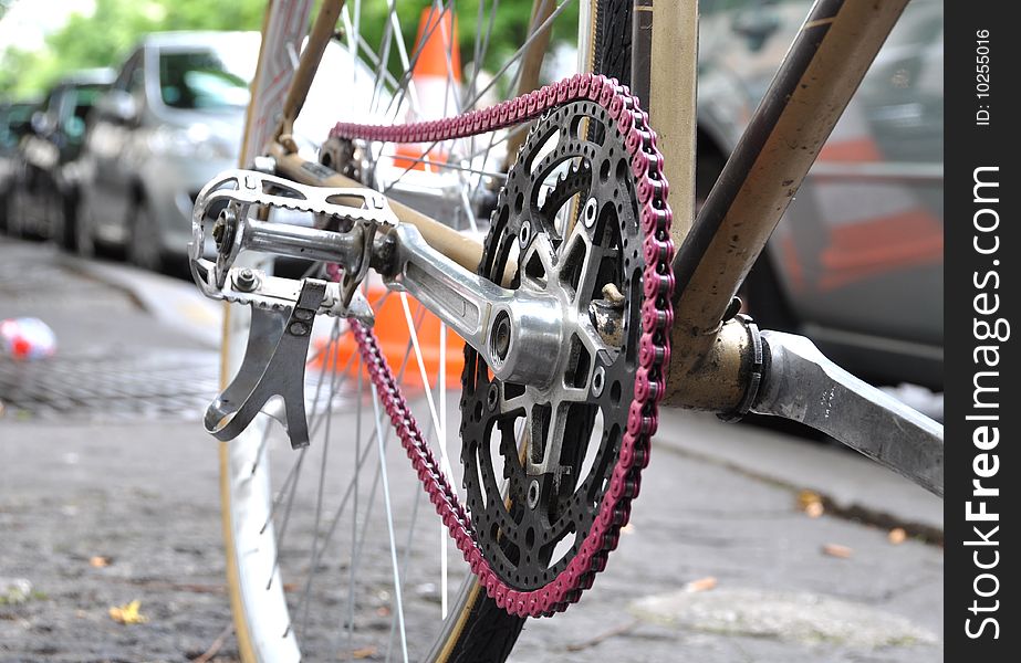 A vintage bicycle with a pink chain