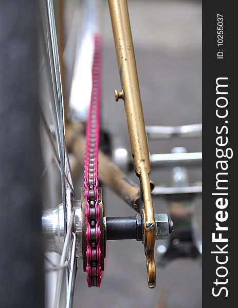 A vintage bicycle and its pink chain